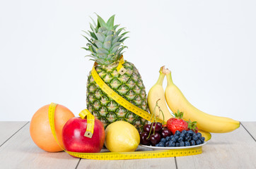 Naklejka na ściany i meble Delicious, colorful fruits and centimeter