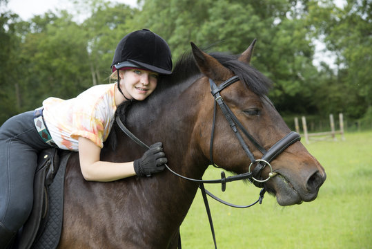Portrait of a young rider with her pony