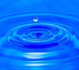 water droplets falling in blue water
