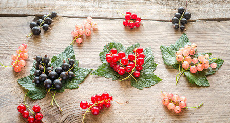Fresh currant on leaves on the wooden board