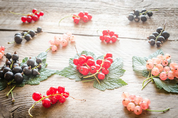 Fresh currant on leaves on the wooden board