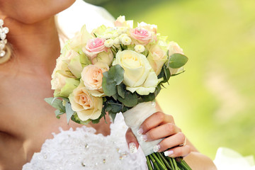 Bride with wedding rose bouquet after wedding ceremony