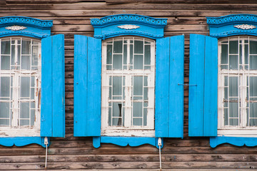 Windows of old, wooden cottage in the countryside