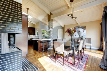 Modern kitchen room interior with fireplace and dining area