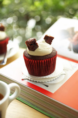 close up chocolate cupcake on book