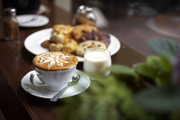 close up hot latte in white cup and cookies