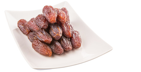 Date fruits on a white plate