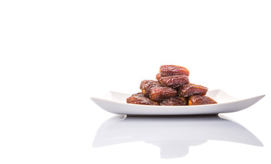Date fruits on a white plate