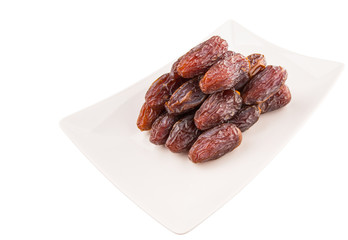 Date fruits on a white plate