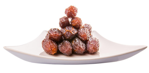 Date fruits on a white plate
