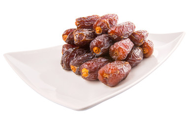 Date fruits on a white plate