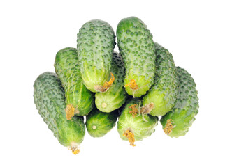 stack of cucumbers with dry flowers isolated over white