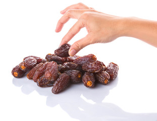 Female hands with date fruits over white background