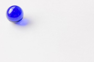 One blue glass marble - Upper left