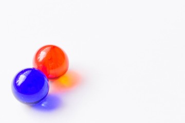 Two blue and red glass marbles - Lower left