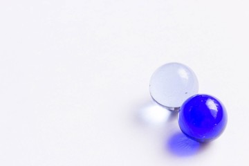 Two blue and clear glass marbles - Lower right