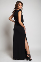 Fototapeta premium Model brunette with long curly hair. Studio photo