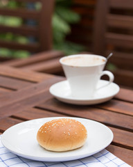 bread with sesame seeds and coffee.