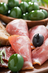 assorted Italian antipasti - deli meats, olives and ciabatta