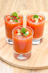 cold tomato soup gazpacho in portion glasses vertical