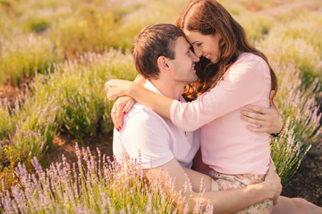Portrait of a young couple posing in summer in the field