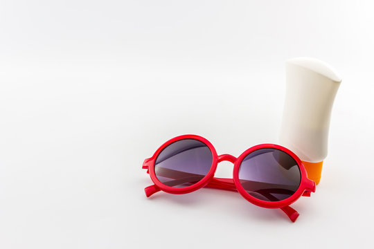 Red sunglasses with body lotion.