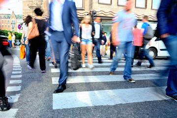 Motion blurred crowd crossing street