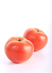 red tomato with water drops, isolated on white background