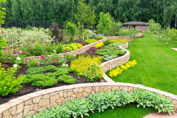 Landscape design in home garden, beautiful landscaping in backyard in summer