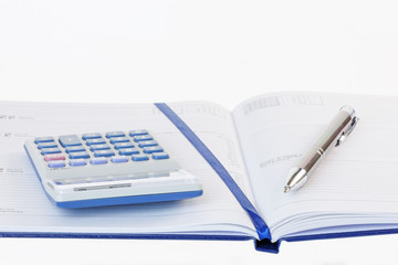Calculator and Pen on a Diary