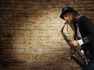 young beautiful woman with saxophone - obrazy, fototapety, plakaty