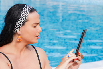 Young woman with touch pad on vacation
