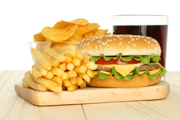 Hamburger, potato free and chips with cola on white background.