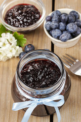 Jar of blueberry jam decorated with blue bow