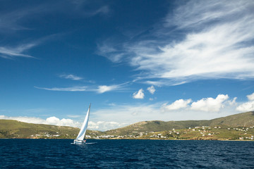 Fototapeta na wymiar Sailboat on peaceful still waters in a harbor.