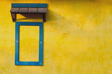 Yellow grunge wall with blur frame window for background