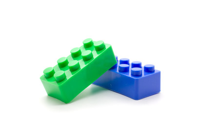 Naklejka premium Plastic building blocks on white background