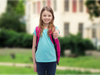 smiling girl with school bag showing thumbs up