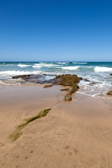 Beach with village and blue sky