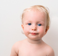 Funny blond baby with blue eyes