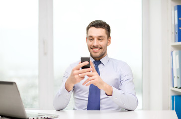 businessman with laptop and smartphone at office