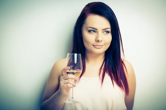 Pretty, young woman having glass of wine