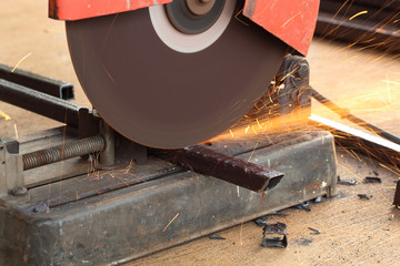 Worker cutting steel rod