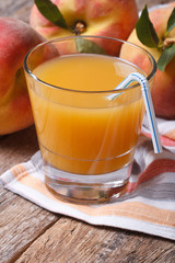 fresh peach juice in a glass on the table close-up vertical