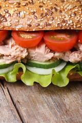 Delicious sandwich with tuna and vegetables macro. vertical