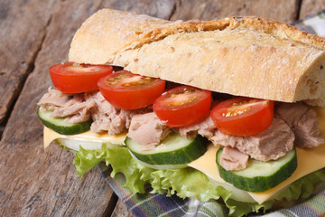 tuna sandwich with vegetables and cheese closeup on wooden