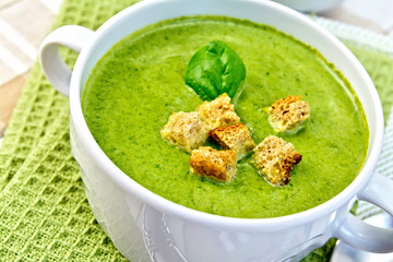 Soup puree with croutons and spinach on napkin
