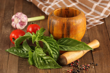 fresh basil, tomato, garlic, wooden mortar