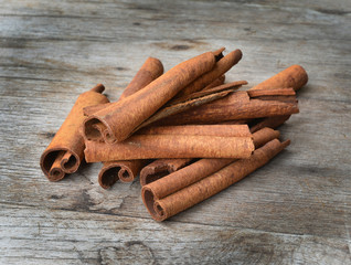 Cinnamon sticks on wooden background