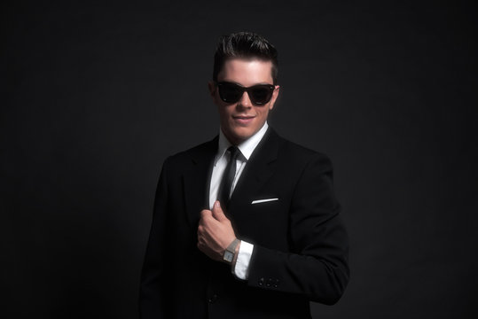 Retro fifties fashion man wearing black sunglasses with suit and